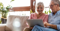 senior couple using laptop at home
