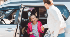 Mom and daughter getting out of car
