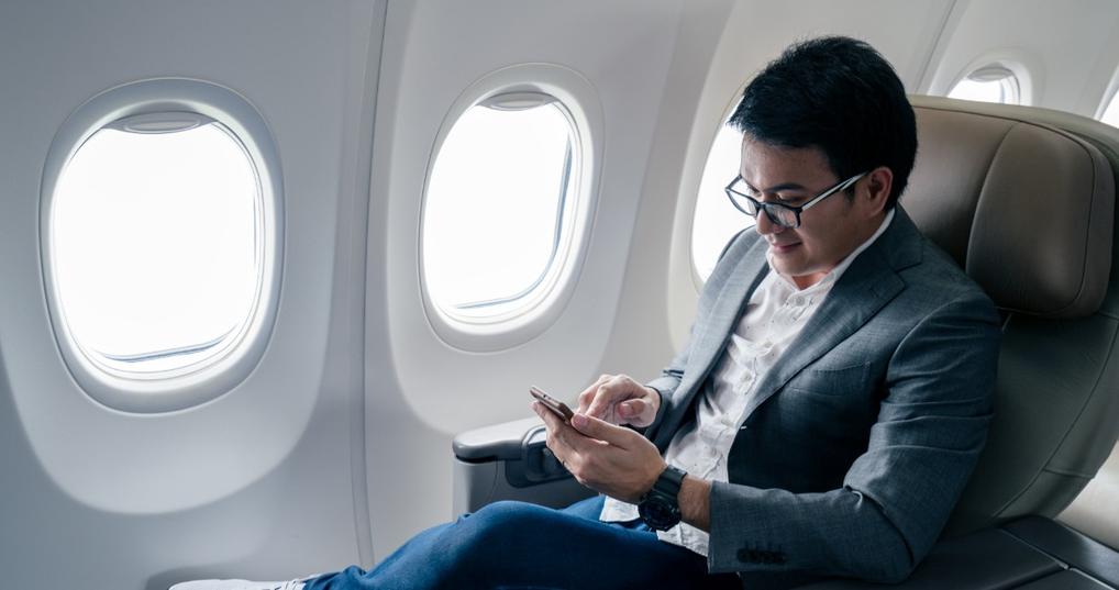 Young businessman sitting in a business class seat