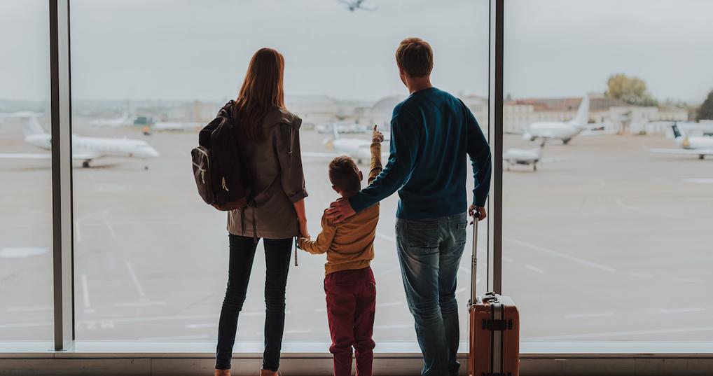 Family watching planes at airport