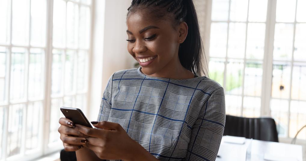 Smiling woman using her smartphone