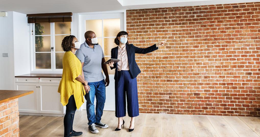 Couple looking at home with Realtor