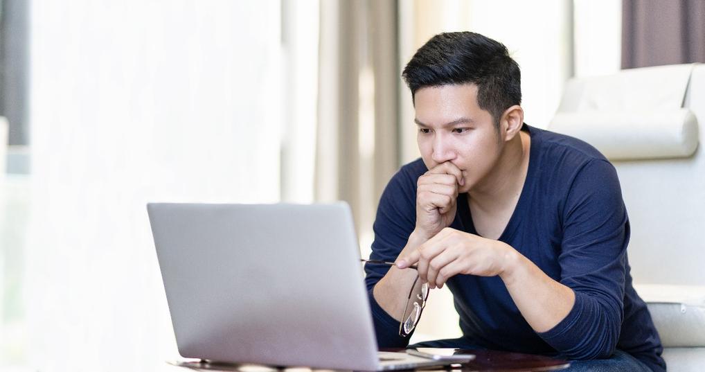 confident asian young freelancer in smart casual working