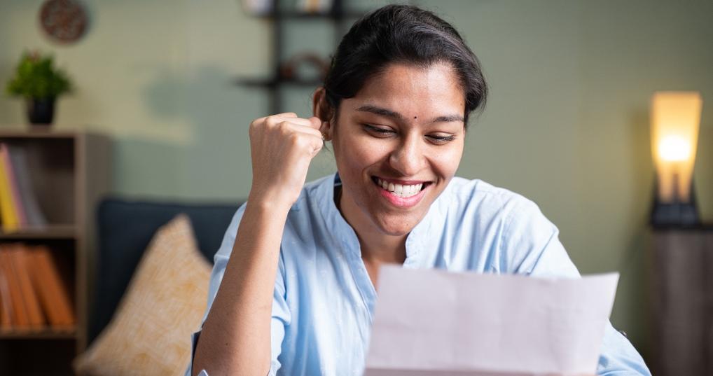 Happy woman reading letter