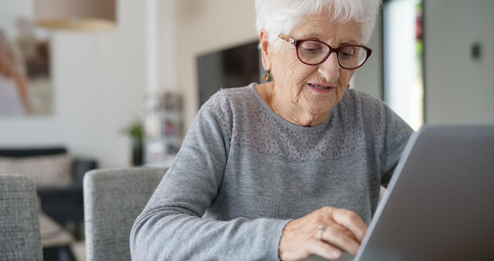 old woman at home using laptop computer