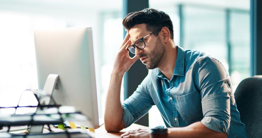 Concerned man looking at computer