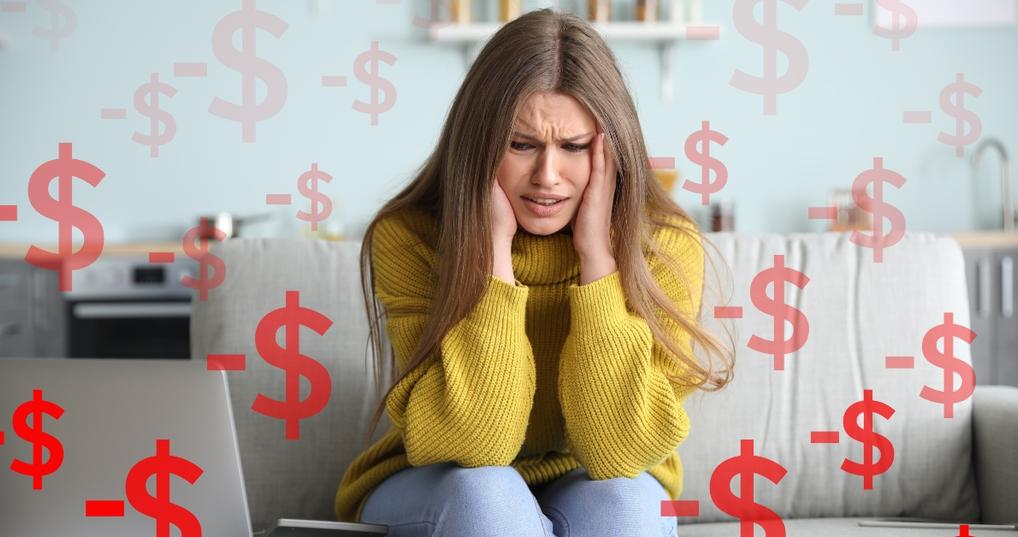 worried young woman in debt at home