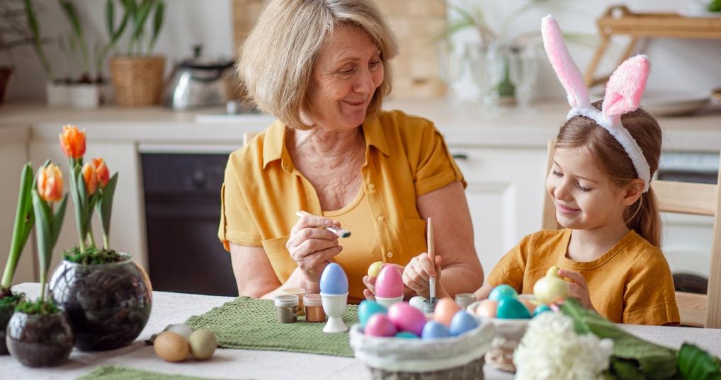 elderly grandmother and little granddaughter with rabbit ears