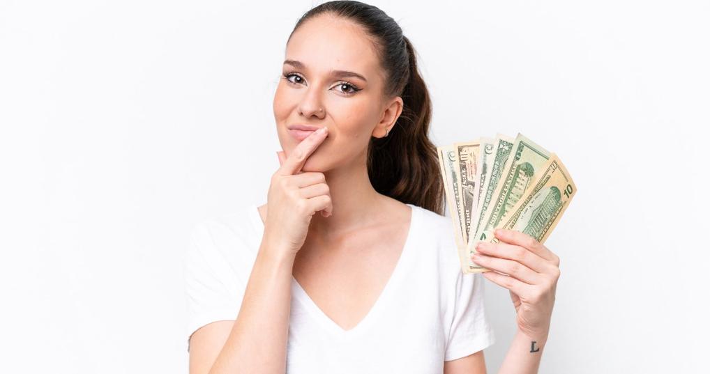 woman flaunting money in hand