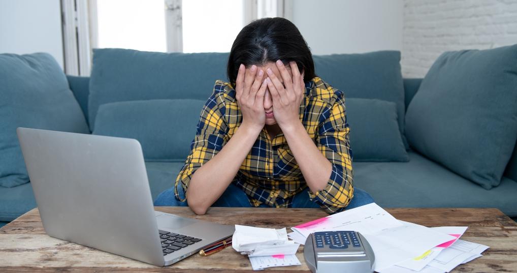Stressed woman will bills and computer