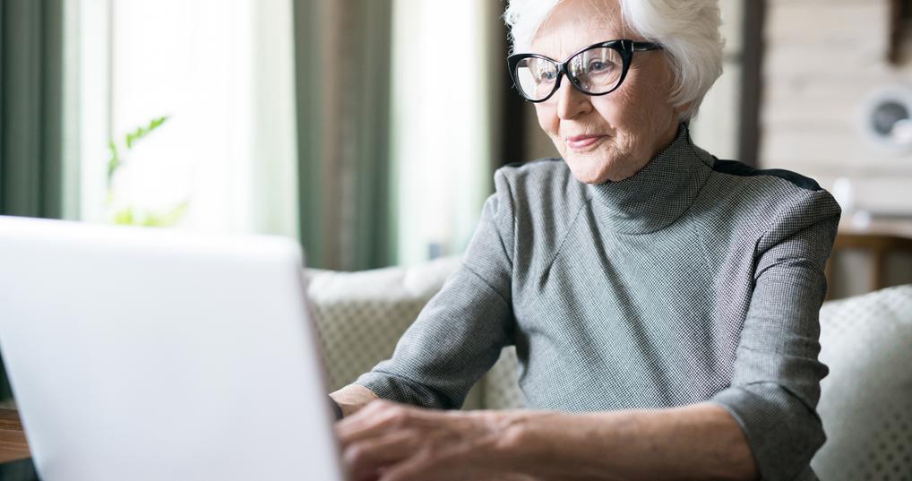 An older woman working on a computer