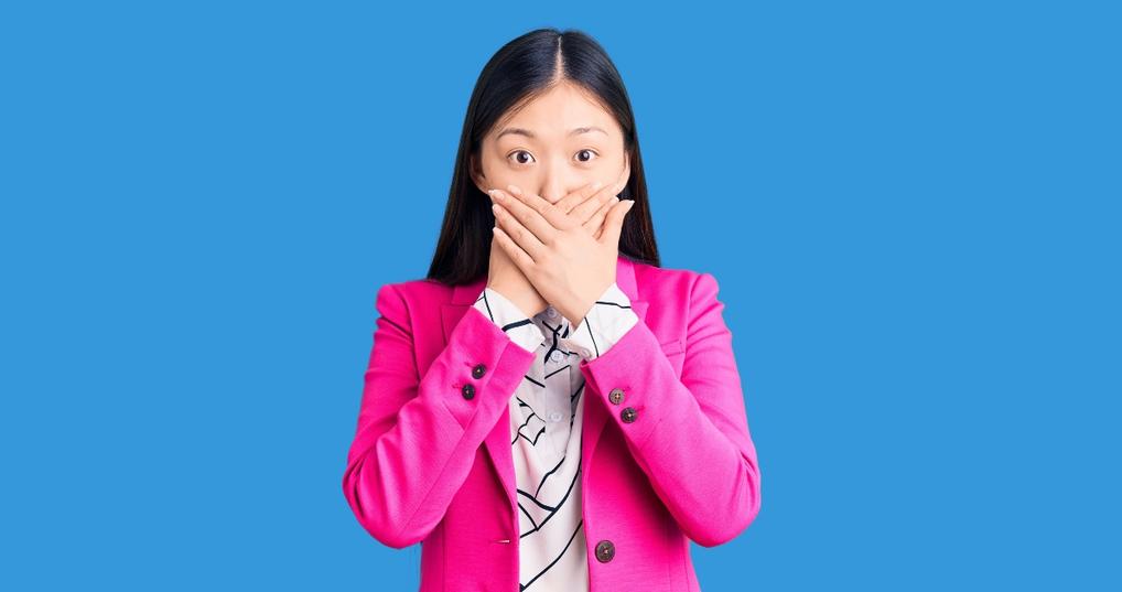 Woman with hands over mouth
