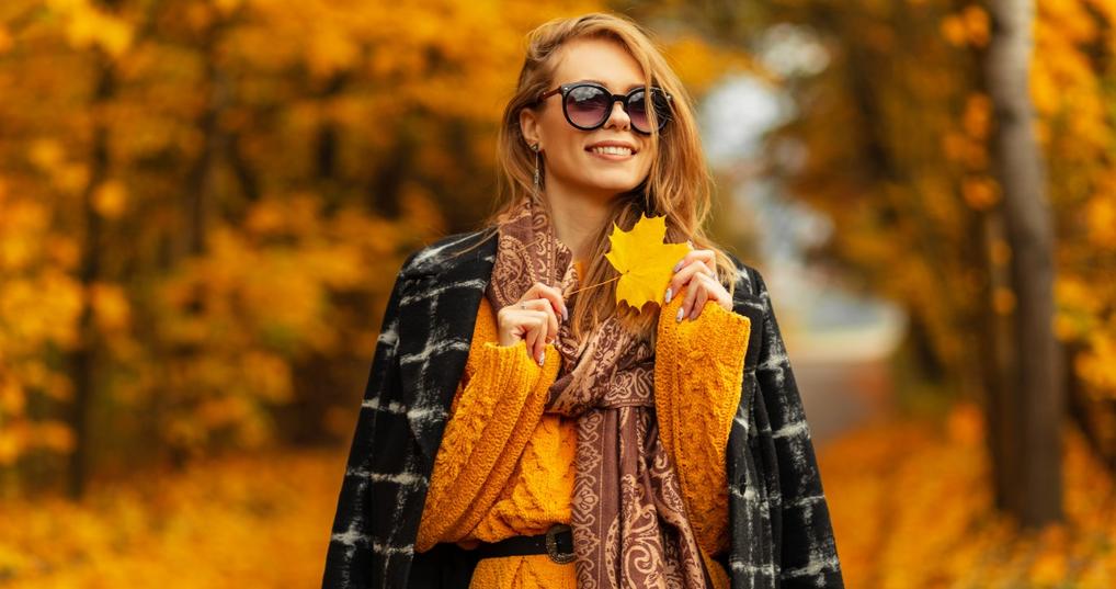 Woman holding a fall leaf
