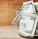 savings dollar in glass jar
