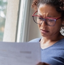 Worried woman looking at bills