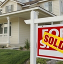sold home for sale sign and house