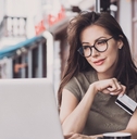 Woman on computer with credit card