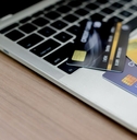 Three credit cards spread out on a laptop keyboard
