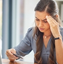 Stressed woman looking at credit card