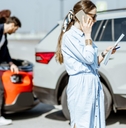 woman calling road assistance after the car collision
