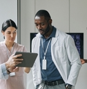 group of doctors looking at digital tablet