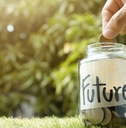 Person putting money in a jar labeled "future"
