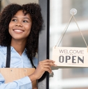 Happy woman holding an open sign