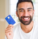 man holding credit card with a happy face