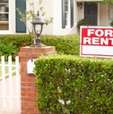 for rent sign in front yard of house in street