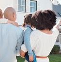 african american family outside new home