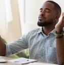 african guy meditating while remote working