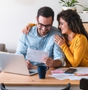 happy couple paying bills online