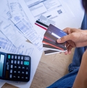 stressed businessman choosing card for bills
