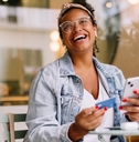 Smiling woman using a credit card