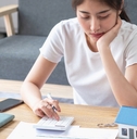 woman sitting and calculating expenses