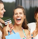 Laughing women shopping with a credit card