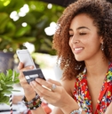Woman holding a credit card and looking at phone