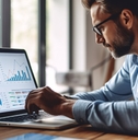 businessman reviewing data on laptop