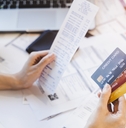 woman looking at many credit cards
