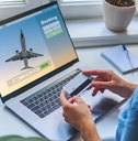 A woman is booking a flight with a credit card