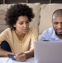 african american family couple calculating expenses