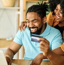 A couple using a cash back credit card online