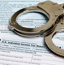 handcuffs over Income tax return documents