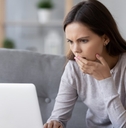 stressed woman reading bad news online