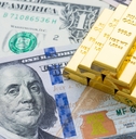 Gold bars on US dollar banknotes