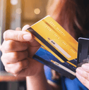 A woman holds three credit cards in her hands. 