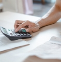 Close up person calculating expenses