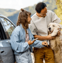 couple with dog at EV charging station