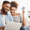 Smiling couple looking at a laptop