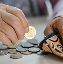 senior woman holding counting coin